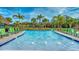 Resort-style lazy river with palm trees and lounge chairs, perfect for relaxation and recreation at 2901 Protagonist St, Kissimmee, FL 34746