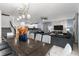The living room features a dining table, pendant lighting, and a dark sofa with a marble accent wall at 2901 Protagonist St, Kissimmee, FL 34746