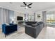 Spacious living room with stylish furniture, tile floors, and natural light from the windows at 2901 Protagonist St, Kissimmee, FL 34746