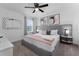 Serene main bedroom with gray furniture, carpet floors, and natural light from the window at 2901 Protagonist St, Kissimmee, FL 34746