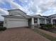 Charming two-story home features a brick driveway, attached two-car garage and a welcoming covered porch at 2659 Park Ridge St, Apopka, FL 32712