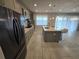 Modern kitchen boasts stainless steel appliances, a center island with seating, and ample natural light for cooking at 2659 Park Ridge St, Apopka, FL 32712