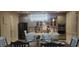 Bright, open kitchen featuring an island with a breakfast bar, modern appliances, and an adjacent dining area at 2659 Park Ridge St, Apopka, FL 32712