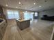 Bright kitchen featuring a center island, stainless steel appliances, and seamless flow into the living area at 2659 Park Ridge St, Apopka, FL 32712