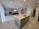 Bright kitchen showcasing a center island, stainless steel appliances, and seamless flow into the living area at 2659 Park Ridge St, Apopka, FL 32712