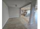 Open-concept living area featuring tile floors and view of modern kitchen with island seating at 2659 Park Ridge St, Apopka, FL 32712