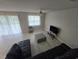 Bright living room with tile flooring, large window and sliding doors at 2659 Park Ridge St, Apopka, FL 32712