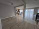 Open-concept living area showcasing modern tile flooring, seamlessly connecting the living room, kitchen, and dining spaces at 2659 Park Ridge St, Apopka, FL 32712