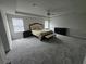 Spacious carpeted main bedroom with tray ceiling, ceiling fan and natural light at 2659 Park Ridge St, Apopka, FL 32712