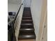 View of the staircase featuring dark wood steps and white banister at 2659 Park Ridge St, Apopka, FL 32712