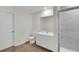 Elegant bathroom with a glass-enclosed shower, wood look floors, and modern fixtures at 2722 Sw 151St Pl, Ocala, FL 34473
