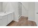 Bright bathroom featuring modern vanity, walk-in shower, and wood look flooring at 2722 Sw 151St Pl, Ocala, FL 34473