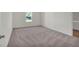 Cozy bedroom featuring plush carpet, a large window, and neutral tones at 2722 Sw 151St Pl, Ocala, FL 34473