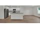 Modern kitchen featuring white cabinets, stainless steel appliances, and a center island at 2722 Sw 151St Pl, Ocala, FL 34473