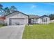 Charming single-story home featuring a well-manicured lawn and a two-car garage at 2645 Sw 163Rd Pl, Ocala, FL 34473