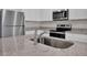 Modern kitchen featuring stainless steel appliances, granite countertops, and white cabinetry at 2645 Sw 163Rd Pl, Ocala, FL 34473
