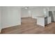 Bright living room with wood floors that flow into an open-concept kitchen at 2645 Sw 163Rd Pl, Ocala, FL 34473
