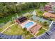 Aerial view of community pool, tennis courts, and canal at 565 Lake Mystic Ln, Lakeland, FL 33813