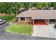 Brick home with carport and landscaped lawn at 565 Lake Mystic Ln, Lakeland, FL 33813