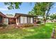 Brick home with a screened patio, storage shed, and a grassy backyard at 565 Lake Mystic Ln, Lakeland, FL 33813
