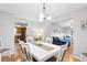 Open dining room with white table and six chairs at 565 Lake Mystic Ln, Lakeland, FL 33813