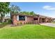 Brick ranch home with carport and well-manicured lawn at 565 Lake Mystic Ln, Lakeland, FL 33813