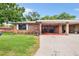 Brick home with carport, and lush landscaping at 565 Lake Mystic Ln, Lakeland, FL 33813