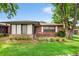 Brick home with a screened patio and well-manicured lawn at 565 Lake Mystic Ln, Lakeland, FL 33813