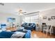 Spacious living room with blue couches and wood floors at 565 Lake Mystic Ln, Lakeland, FL 33813