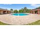 Community pool with brick patio and adjacent buildings at 565 Lake Mystic Ln, Lakeland, FL 33813