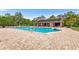 Community pool with brick patio and covered seating area at 565 Lake Mystic Ln, Lakeland, FL 33813