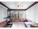 Sunroom with brick walls, tiled floor, and comfortable seating at 565 Lake Mystic Ln, Lakeland, FL 33813