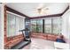 Sunroom with brick walls, tiled floor, and a treadmill at 565 Lake Mystic Ln, Lakeland, FL 33813
