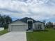 Attractive single-Gathering home with a well-manicured lawn, a two-car garage, and a welcoming entrance at 5251 Sw 164Th Street Rd, Ocala, FL 34473