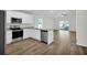 Well-lit kitchen with modern stainless steel appliances, granite countertops, and an open layout to the living area at 5251 Sw 164Th Street Rd, Ocala, FL 34473