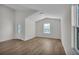 Bright, open living area showcases luxury vinyl plank flooring, natural light, and a vaulted ceiling creating a spacious atmosphere at 5251 Sw 164Th Street Rd, Ocala, FL 34473