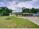 Charming single-story home featuring a lush front lawn and screened patio for comfortable outdoor living at 10161 Sw 87Th Ter, Ocala, FL 34481