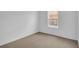 Simple carpeted bedroom with a window providing natural light and ventilation at 418 Marion Oaks Ln, Ocala, FL 34473