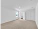 Neutral bedroom featuring carpet flooring, a large window, and an ensuite bathroom at 418 Marion Oaks Ln, Ocala, FL 34473