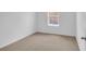 Bright bedroom features neutral carpet, white walls, and a window for natural light at 418 Marion Oaks Ln, Ocala, FL 34473