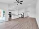 Spacious living area showcasing an open floor plan, modern kitchen, and vinyl flooring at 418 Marion Oaks Ln, Ocala, FL 34473