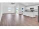 Open-concept living area with wood-look flooring, vaulted ceilings, and lots of natural light at 418 Marion Oaks Ln, Ocala, FL 34473
