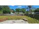 An outdoor patio space framed by a wooden fence and verdant greenery at 1814 Lowry Ave, Lakeland, FL 33801