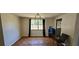 A dining area with a large window and classic light fixture at 1814 Lowry Ave, Lakeland, FL 33801