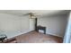 A carpeted living room with overhead lighting and a storage console at 1814 Lowry Ave, Lakeland, FL 33801