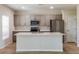 Modern kitchen with island, stainless steel appliances, and ample cabinetry at 2036 Marigold Aly, Winter Haven, FL 33884