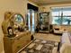 Airy bedroom features elegant vanity with mirror and a glass display cabinet, complementing the serene decor at 8339 Bridgeport Bay Cir, Mount Dora, FL 32757