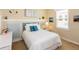 Cozy bedroom with a white-quilted bed, blue accent pillows, and a sunlit window at 8339 Bridgeport Bay Cir, Mount Dora, FL 32757