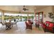 Spacious covered patio with ceiling fans, comfortable seating, and a picturesque lake view at 8339 Bridgeport Bay Cir, Mount Dora, FL 32757