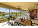 Inviting outdoor patio with dining table, comfortable chairs, and scenic water views at 8339 Bridgeport Bay Cir, Mount Dora, FL 32757